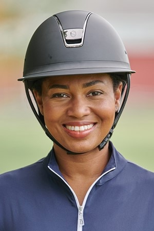 Woman wearing a black equestrian helmet